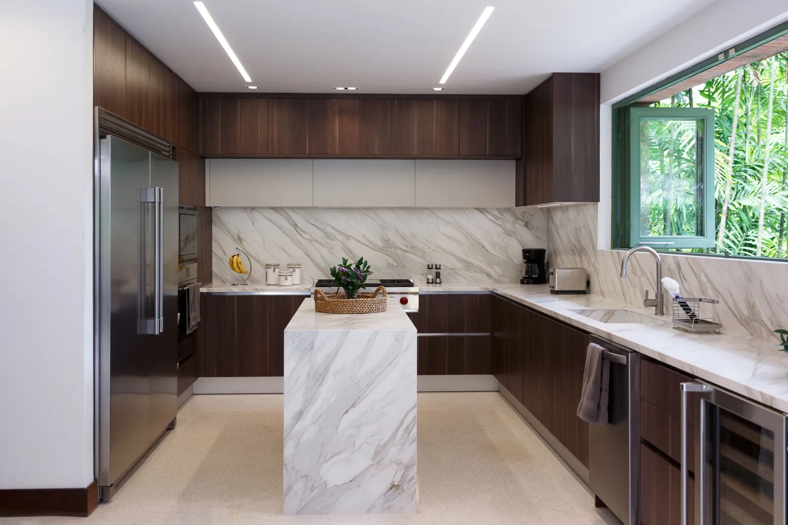 Vanity wall with vessel sinks and backlit mirrors