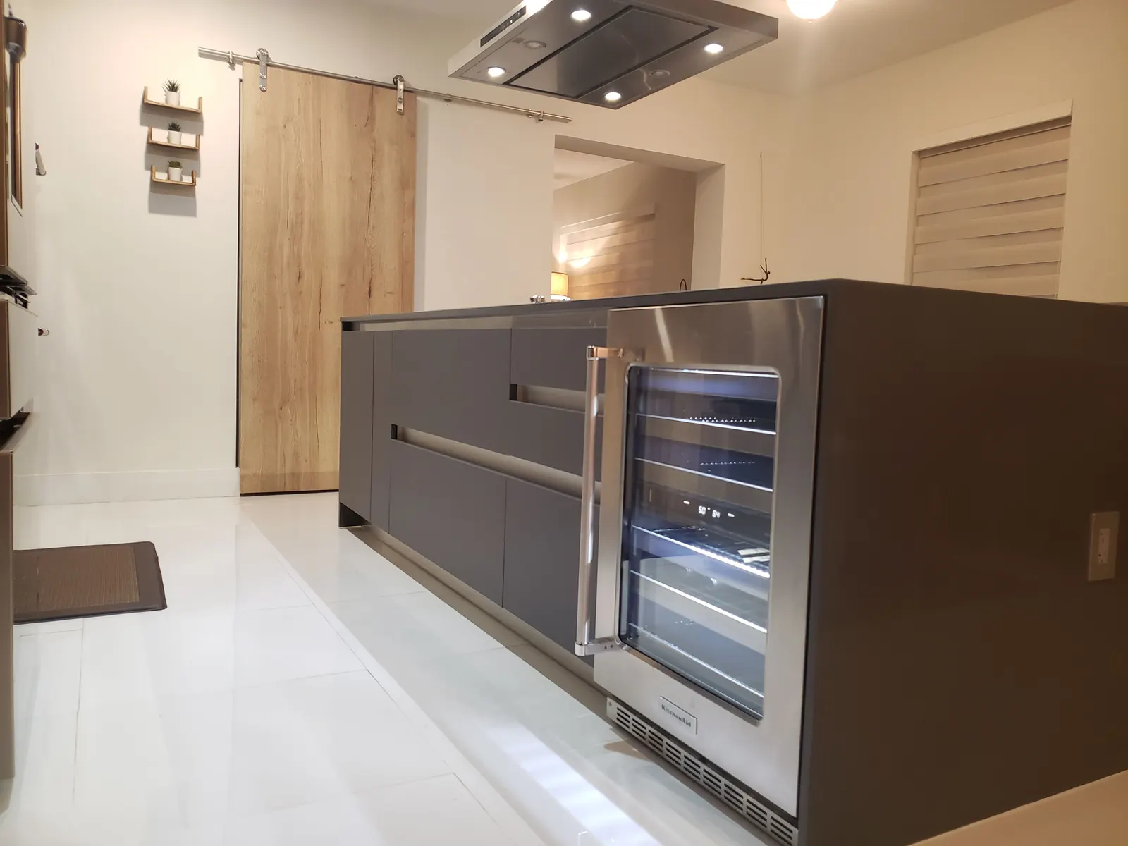 Kitchen island with undercounter beverage cooler and barn door